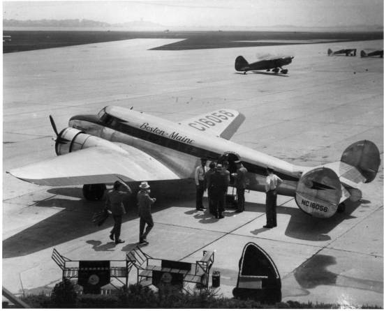 The Lockheed Electra 10 is shown loading Northeast Airline passengers at Boston Airport.  The Stinson Gullwing in the background may also have been owned by Northeast or its predecessor Boston & Main