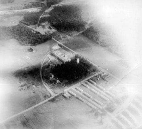 Main Gate area at Ault Field, NAS Whidbey Island, Washington, 1946. Parachute rigger towers visible.