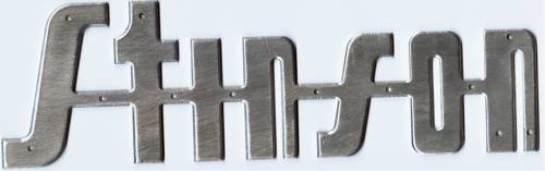 A Stinson logo, executed in light metal.