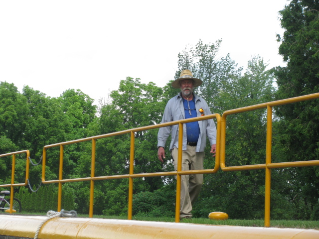 The Lockmaster at Lock 33 on the Erie Canal, peers at boat in lock.