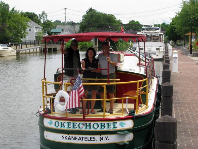 Erie Canal cruise boat stops at Fairport, New York. Other craft visible.