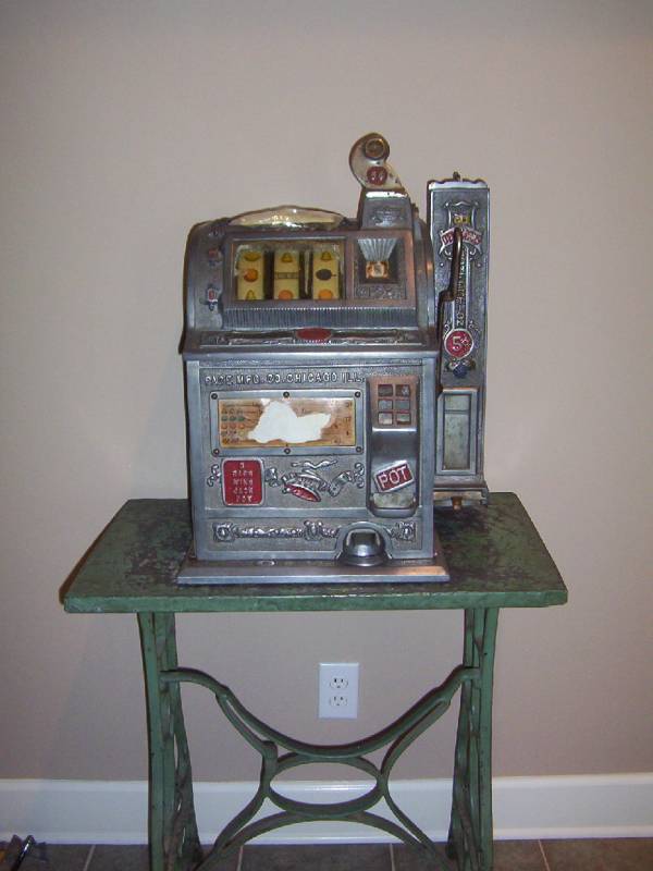 An early 5-cent slot machine; 3-cherries was one of the winners