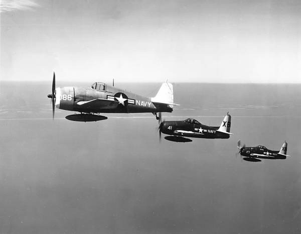 The F6F in the forefront is an F6F-5K drone being controlled by the F8Fs  alongside. For the hard grind of the Pacific War the F6F was the Navy's carrier mainstay. The F8F made its appearance in the 