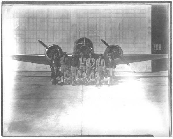 Class of Nov.-Dec. 1945 at NAS Banana River, Florida studying  the APA-5B radar enhanced bombsight based on the Norden design. The aviators and instructors pictured are shown in front of an SNB in a 